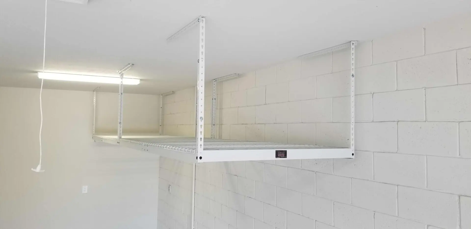 A white overhead rack on a white wall