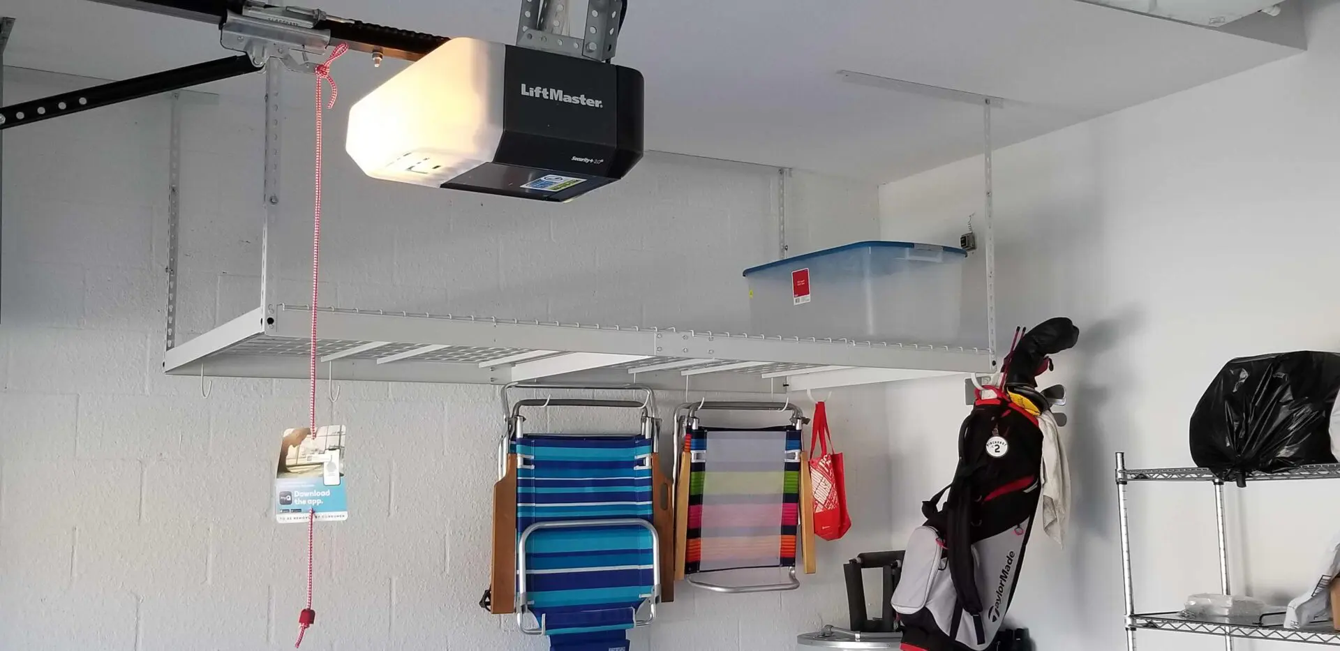 An overhead rack with foldable chairs on its hooks