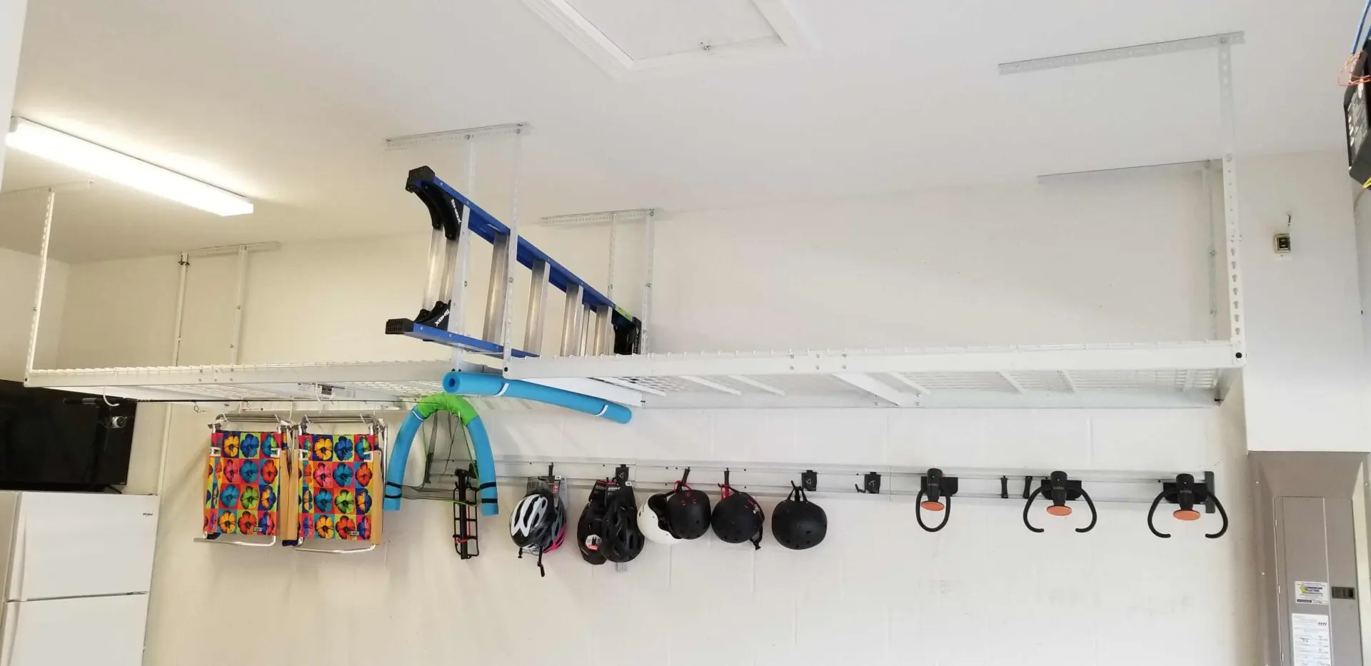 A ladder on the overhead storage and helmets on the hooks